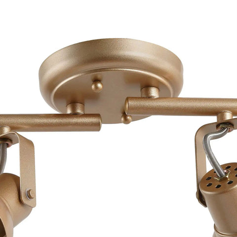 Close-up of gold LED track lighting kit ceiling mount and rotatable spotlight heads