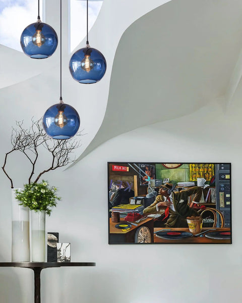 Hand Blown Glass Pendant Light For Kitchen Island Capri Blue Globe Seeded Bubbles Lit Eight Point Seven Inch Diameter 60 Inch Adjustable Cord ETL Listed Modern Ceiling Light in a contemporary interior.