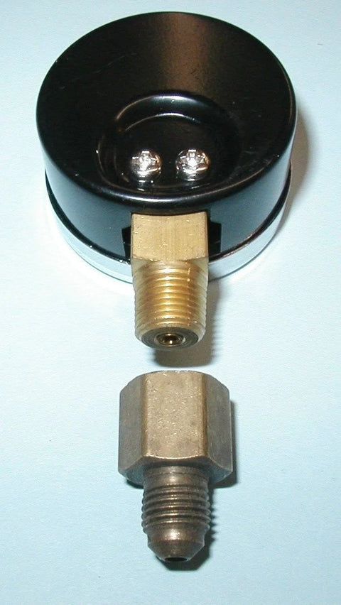 Front view of oil burner fuel pressure test gauge; black circular housing with brass threaded inlet and hex nut.