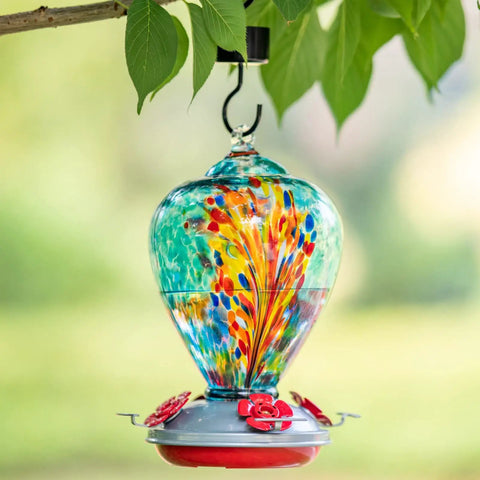 Blown Glass Hummingbird Feeder For Outdoors Hanging 34oz Comet Design, vibrant blue, hanging on tree outside