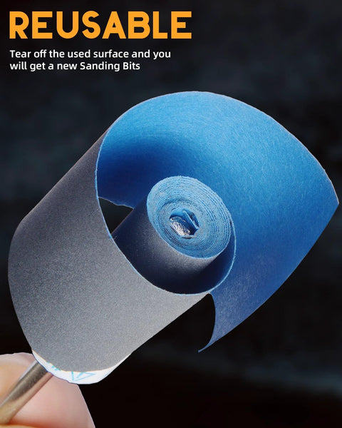Blue sanding paper roll wound into a tight spiral, held by a finger