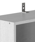 Close-up of 70 inch tall shelf's top corner from Pair Of Six Tier Floor Standing Bookshelves; MDF construction and tipover resistant design.