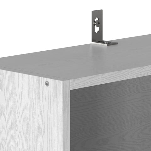 Close-up of 70 inch tall shelf's top corner from Pair Of Six Tier Floor Standing Bookshelves; MDF construction and tipover resistant design.