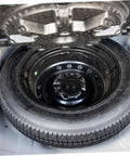 Spare Tire Hold Down Bolt For Cars Easy Install Replacement Retainer Clamp Keeps Your Spare Wheel From Rattling And Bouncing On Rough Roads Versatile Fit For Most Vehicles And SUVs securing a spare tire in a car trunk.