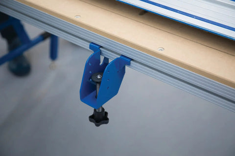 Close-up of blue adaptive cutting system extension bracket bolted onto a workbench for easy setup. Level Up Your Shop Rig With These Knockout Adaptive Cutting System Extension Brackets That Bolt Right Onto Standard Workbenches Or Portable Project Tables For Quick Setup.