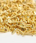 Beefy Brass Countersunk Wood Screws Self-Tapping M3x30 20Pcs Set Dual End Locking scattered on white surface