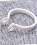 Close-up of white plastic curtain ring from 60 Pack Plastic Curtain Rings For Rods Thick Durable Construction With Smooth Glide For Heavy Curtains