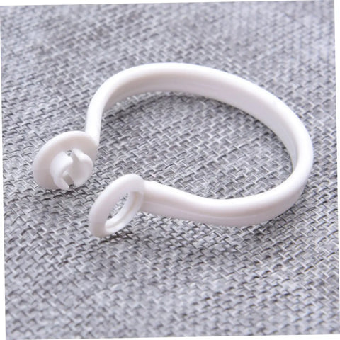 Close-up of white plastic curtain ring from 60 Pack Plastic Curtain Rings For Rods Thick Durable Construction With Smooth Glide For Heavy Curtains