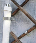 304 Stainless Steel Conduit Pipe Clamps Mounting Brackets One-Hole P-Type Clips securing a white pipe on wooden beams