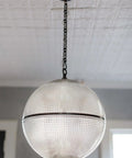 Straight Killer One Light Ceiling Pendant With Distressed Bronze Brass Frame And Textured Glass Dome hanging in a bright room.