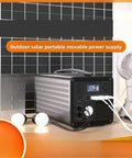 Heavy Duty Portable Power Station 220V Solar Generator With Multi Outlets Compact Backup Energy Kit Trail Ready For Campouts Road Trips And Weekend Getaways Black, shown with solar panels and lamps.