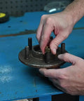 Person using Rethreading Die 3/8-16 NC National Coarse Right Hand High Carbon Steel for damaged bolt thread repair on metal piece