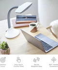 SmartLight Full Spectrum LED Desk Lamp With Adjustable Brightness And Flexible Gooseneck USB Charging Port on a desk with laptop