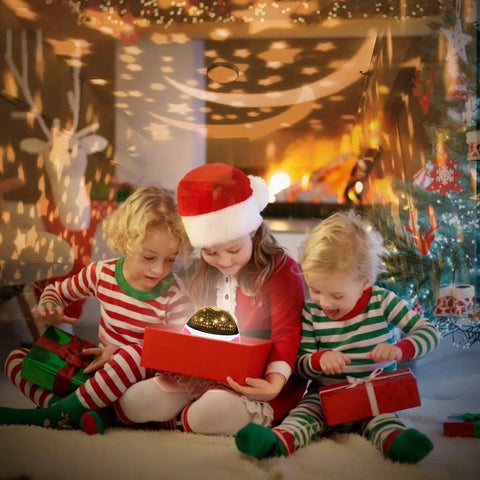 Kids with Christmas gifts enjoying Kids Night Light Projector With Timer And Music, Starry Sky Projector For Bedroom