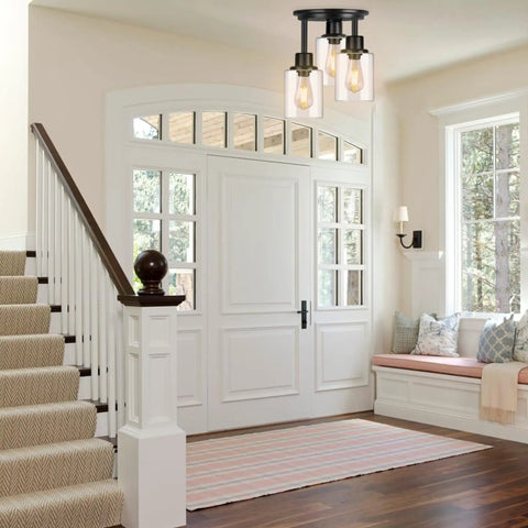 Three Light Matte Black Dope Semi Flush Mount Ceiling Light With Clear Glass Shades installed in stylish foyer.