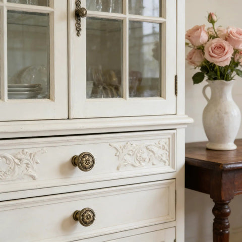 Antique Brass Cabinet Knobs 12 Pack Floral Carved Round Dresser Hardware on rustic white cabinet with floral carvings.