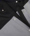 Close-up of Tough As Nails Welding Jacket With Dual FR Fabric Construction showing gray panels and black cotton