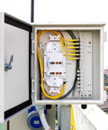 Open network panel with FC APC Square Single Mode Fiber Optic Coupler and Simplex Cable Adapter Pack Of 4 installed for signal distribution.