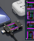 2 In 1 Digital USB Tester Meter With Type C Connector USB C Voltage Current Power Capacity Ammeter Voltmeter PD Battery Gauge QC Two Point Zero And Three Point Zero Fast Charge Recognition Cable Impedance Tester Checking Charging Speed on desk with power strip.