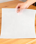 Hand holding 8 By 12 Inch White PTFE Virgin Sheet 1.5mm Thick Nonstick Heat Resistant Teflon Sheet For Baking And DIY Craft Projects