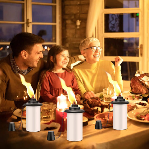Citronella Outdoor Torches Set Of 6 White 16 Oz Each With 59 Inch Metal Poles And 3 Prong Grounded Stakes For Backyard Patio Garden Decor Keeps Bugs At Bay And Creates A Cozy Vibe For Parties shown in a cozy dinner setting.