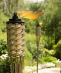 Twelve Pack Bamboo Torches For Patio And Backyard 57 Inch Tall Weather Resistant Citronella Torches in garden setting
