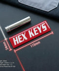 Close-up of red magnetic label for 'HEX KEYS', part of 35 Pack Magnetic Toolbox Labels Set For Tool Chests And Drawers, 3mm Thick DuraGloss Epoxy Tags, Oil Resistant Red Mechanic Labels For Steel Carts And Cabinets, Pro Grade Grippy Organization For Shop Garage And Workbench