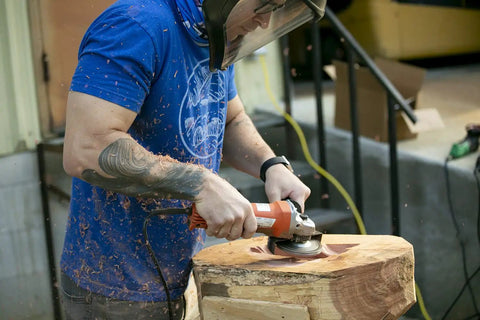 Person using No Bull 4 Inch 14 Tooth Carving Saw Disc For Angle Grinders on wood, carving and shaping materials.