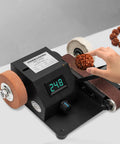 96 Watt 7 Speed Mini Belt Sander Bench Grinder And Polisher featuring dual wheels, with a user polishing a wood piece.
