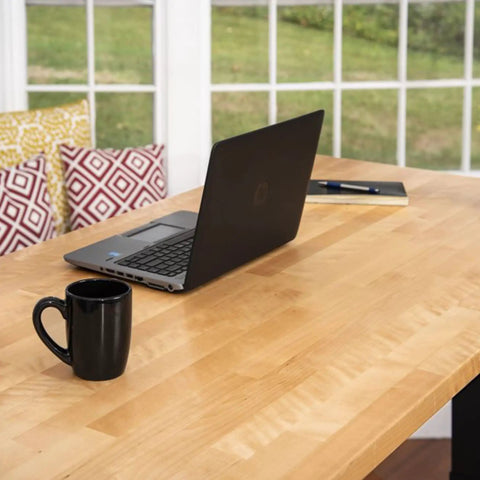 Slick Electric Standing Desk With Genuine Solid Wood Top And Easy Programmable Memory Controls Dual Motor Lift Mechanism For A Hustle Ready Sixty Inch Workstation Setup showcasing a black laptop and coffee mug.