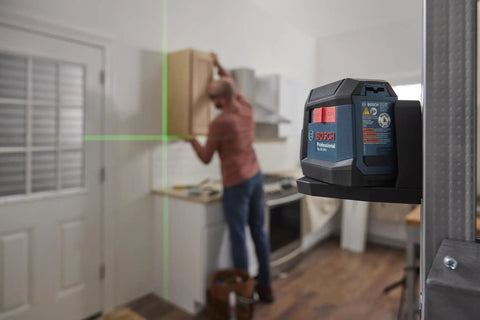 GLL50-20G 50 Ft Green-Beam Self-Leveling Cross-Line Laser With Integrated Magnetic Mount in use on kitchen cabinet installation