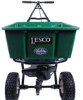 Front view of 50Lb Push Spreader With Enclosed Gearbox And Powder Coated Steel Frame, large green hopper, and durable tires.