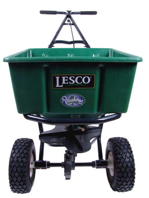 Front view of 50Lb Push Spreader With Enclosed Gearbox And Powder Coated Steel Frame, large green hopper, and durable tires.