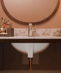 View of a bathroom vanity with a rectangular undermount white porcelain sink and matte black drain set