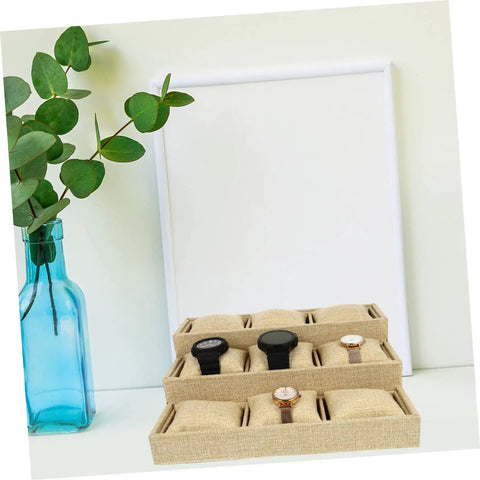 Slick Nine Grid Linen Watch Organizer Tray With Snug Padded Pillows displaying four watches on a light background.