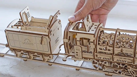 3D Model Steam Locomotive Kit With Tender For Builders And Hobbyists, Gear Driven Train Replica With Rubber Motor, Vintage Steam Era Style For DIY Railfans And Train Nerds. Wooden locomotive and tender model with hand on cab