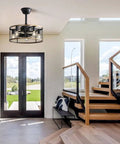 20 Inch Industrial Cage Ceiling Fan with 7 ABS Blades hanging in a modern entryway with glass doors and wooden stairs.