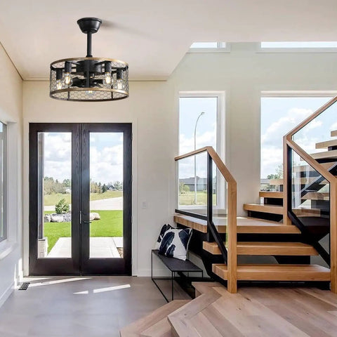 20 Inch Industrial Cage Ceiling Fan with 7 ABS Blades hanging in a modern entryway with glass doors and wooden stairs.