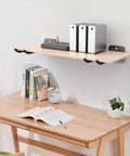 Stylish light wood desk shelf with books and clock above a workspace, showcasing neat organization.