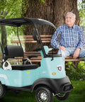 Heavy Duty 60V 800W AC Motor Mobility Scooter With 14.9 Inch Tires And Heckuva 28 Mile Range, really smooth operator parked by a bench.