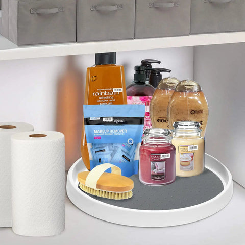 Set Of Two 12 Inch Non Skid Lazy Susan Organizer Smooth Spinning Turntable For Pantry Cabinet Kitchen Storage Game Changer With Super Grippy Rubber Base And Ball Bearings holding various personal care items in a cabinet.