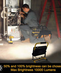 Work Light With Stand 100W 10000LM Portable Construction Flood Light illuminating a technician in a workshop setting