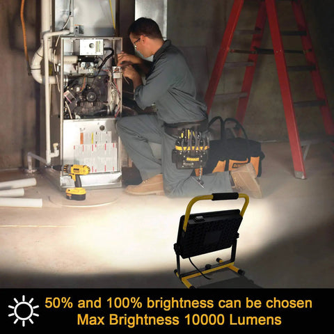 Work Light With Stand 100W 10000LM Portable Construction Flood Light illuminating a technician in a workshop setting