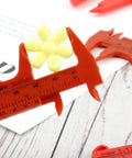 Depth Vernier Caliper 3inches, 6inches Depth Vernier measuring a yellow flower with visible scale on red plastic caliper.