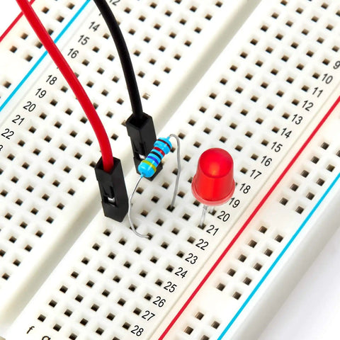 Close-up of Three Pack 400 Tie Point Solderless Breadboards Kit with dual power rails, resistor, LED, and jumper wires.