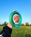 Hand holding Blue Kite String Reel With Lock, 650ft Spool, 7.2 Inch Line Winder for easy string management in a field