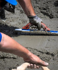White Lightning Hand Float For Concrete, 16 Inch Blade By 3 Inch, in use on wet concrete surface. Durable polymer blade visible.