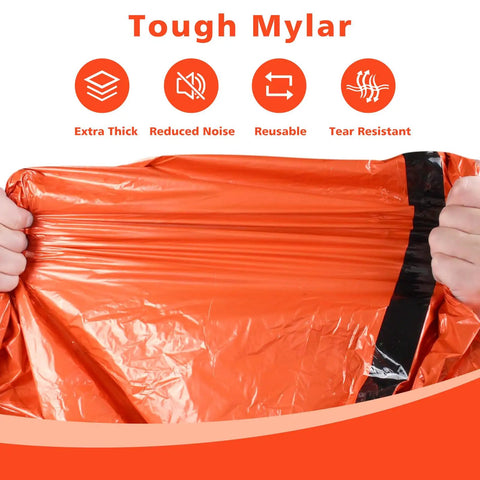 Hands stretching an orange waterproof Emergency Mylar Sleeping Bag Set for Camping showing durability and thickness.