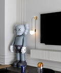 Set Of Two Brushed Gold Plug In Wall Sconces With White Glass Globe Shades Dope Modern Indoor Wall Lights With Cord For Bedrooms Easy Plug In Decor Lighting Minimalist Style beside a stylized figure and TV in modern living room
