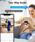 Woman using a phone with Wireless Video Doorbell With Dual Cams Front Door Security Cam And Ground View Includes Chime No Monthly Fee 2K HDR Night Vision Easy App Setup Real Time Alerts For Modern Home Security app interface on screen, showing delivery person.
